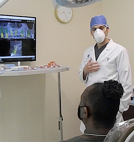 Dentist using advanced oral surgery technology to explain treatment plan