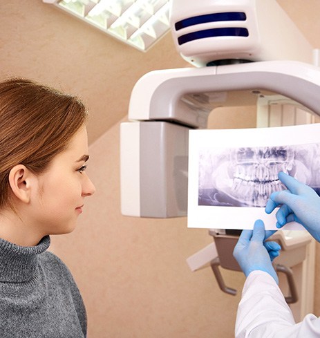 Dentist and patient discussing results of dental scan