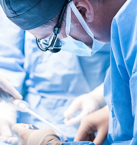 Oral surgery team carefully performing bone graft procedure