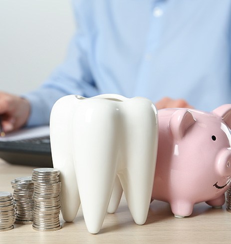 Coins next to a piggy bank