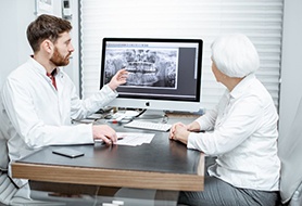 dentist showing a patient their X-rays 