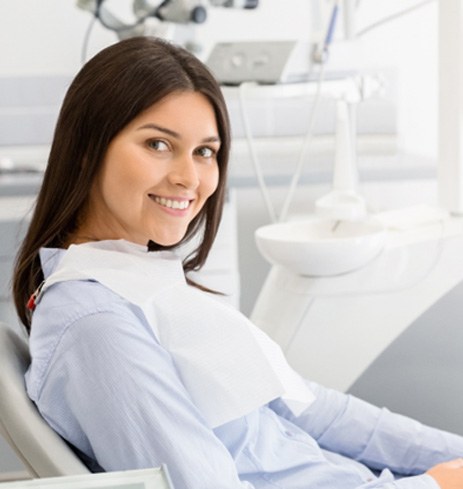 Woman smiling after getting dental implants in Dumfries, VA