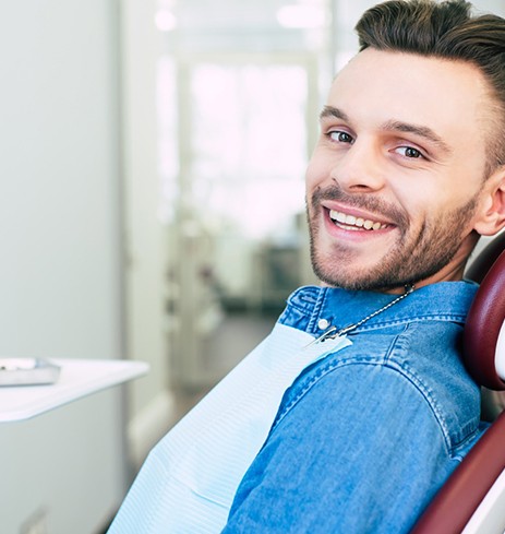 Smiling patient at appointment for dental implant salvage