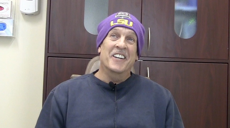 Man in purple beanie sitting in oral surgery office in Dumfries
