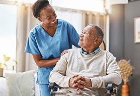 a nurse talking to a patient in a wheelchair