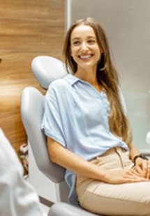 Female patient smiling at oral surgeon near Woodbridge