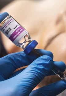 Patient in Parker covering their mouth