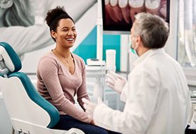  Smiling patient talking to dentist during consultation