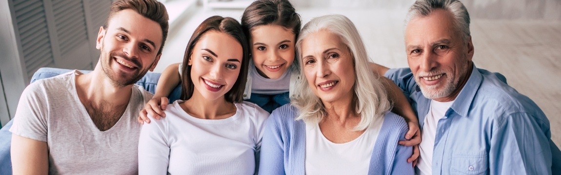 Group of people smiling together after oral surgery