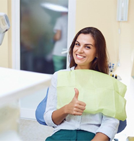 Woman giving thumbs up after wisdom tooth extraction in Dumfries, VA