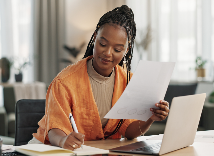 Woman working at a desk with laptop