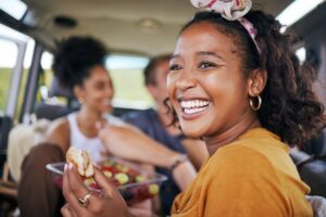 Woman smiling and eating food